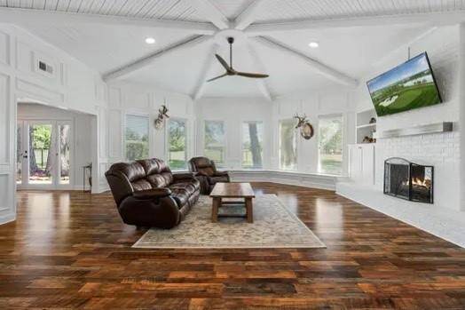 Open the door and you are taken back by the beautiful and unique living room that features an octagonal beam ceiling with plenty of natural light and a full wall of window seating.