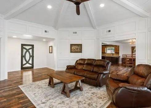 The architectural details are abundant with this custom home! A gorgeous door allows natural light to flow into the entry, box molding highlights the freshly painted walls, and the wood beans that enhance the ceilings are just as beautiful!