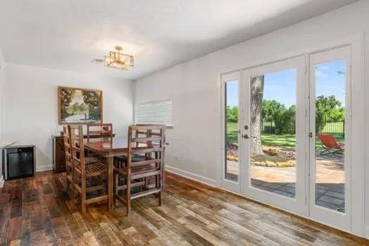 Gorgeous laminate wood flooring flows throughout most of the home creating a seamless look that is so easy to maintain!  This casual dining space is large and offers amazing views through the French door overlooking the backyard space!