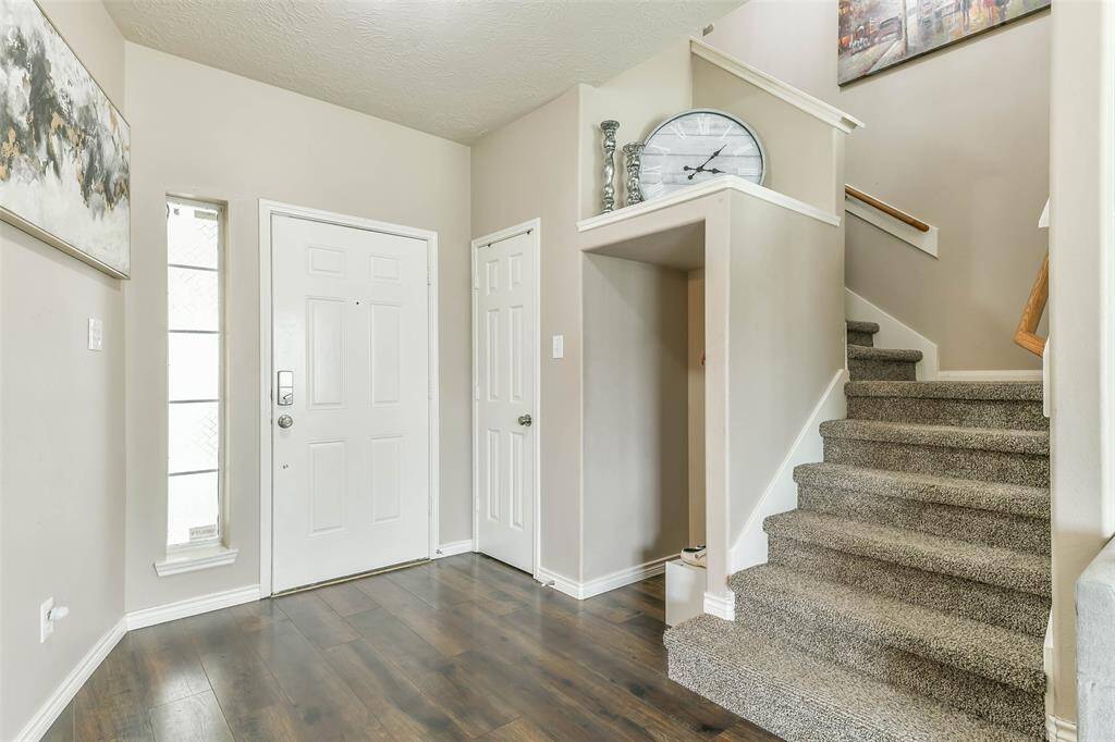 Oversized entry with storage closet and space to accommodate shoes, purses and backpacks. Stairs lead to second floor