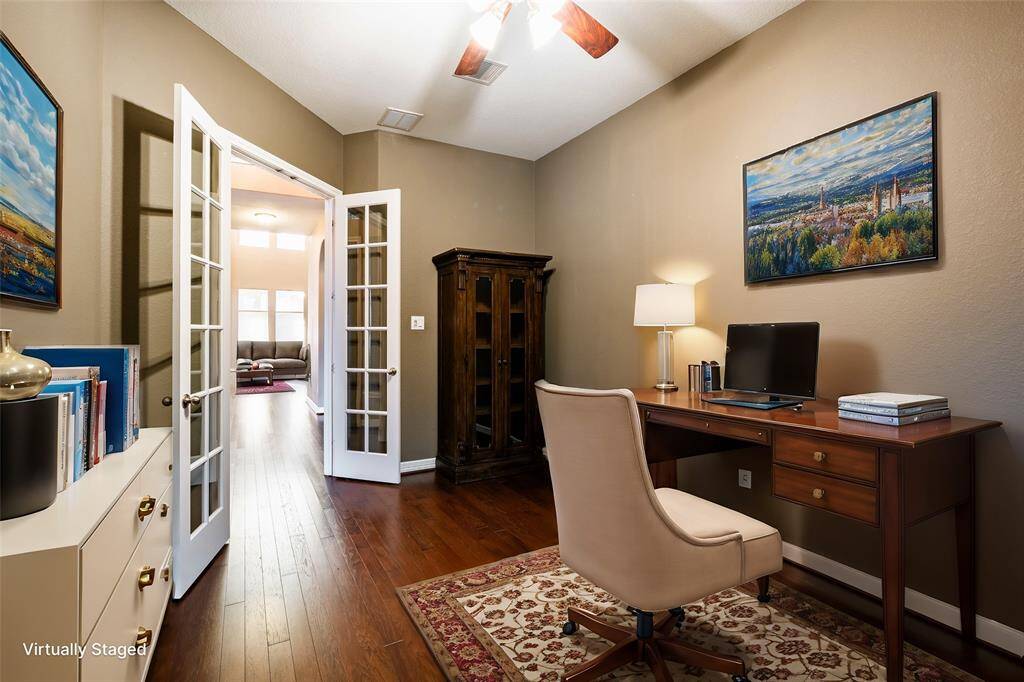 This elegant study offers a quiet and functional space with rich hardwood floors and neutral walls, creating a professional yet warm ambiance. The centerpiece is a stunning Restoration Hardware St James Bookshelf, showcasing timeless craftsmanship and providing ample storage for books or decor. French doors with glass panes enhance the room's openness, allowing natural light to flow in while maintaining privacy. With its refined design, this study is perfect for work, reading, or relaxation.