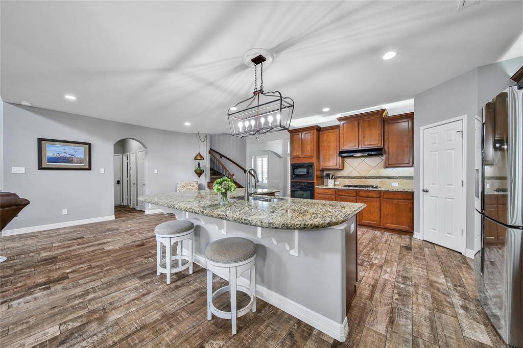 Heart of the home right here!  Wrap around island with seating for four, this kitchen is equipped with a walk in pantry, cabinet lighting and built in appliances.