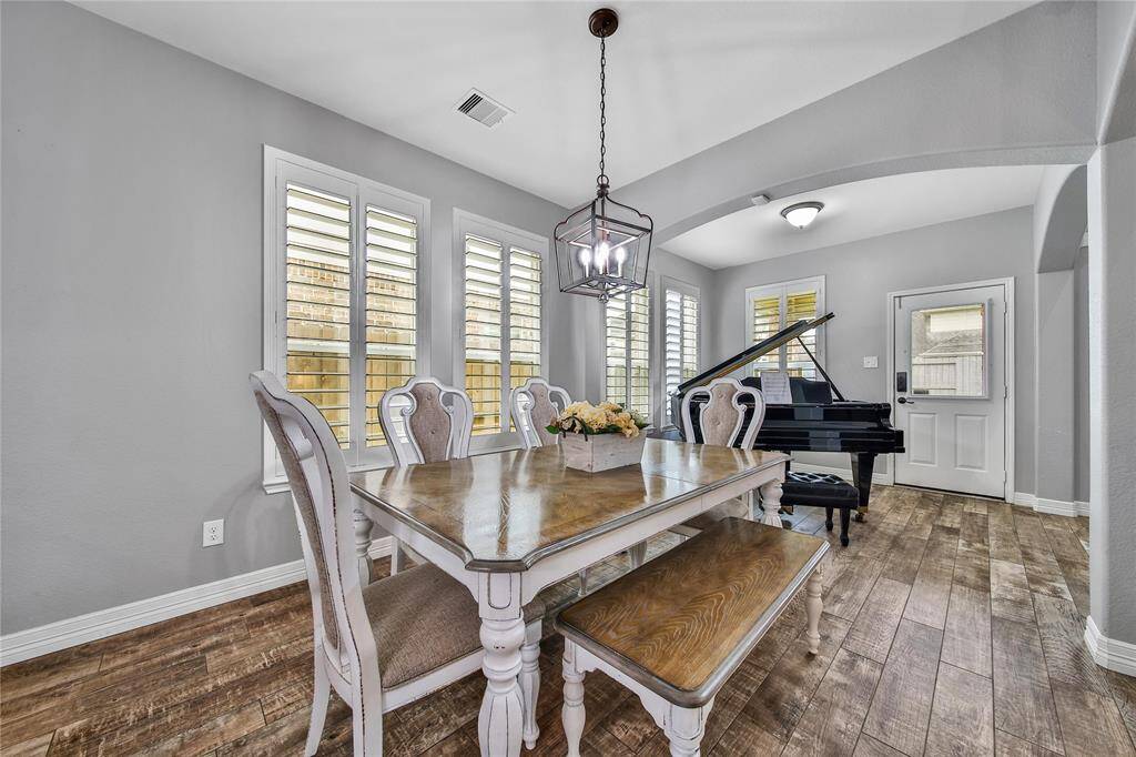 Breakfast space along side the the sunroom just next to the backdoor leading to the covered back patio.