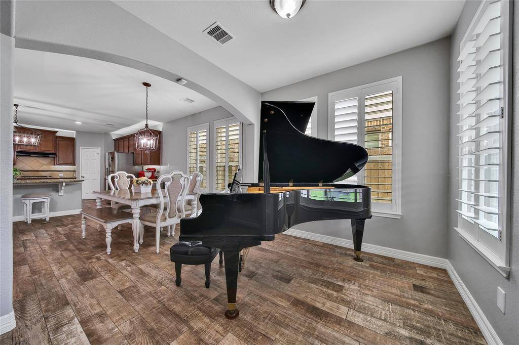 Let the light!  This "sunroom" is currently being used as a piano practice room!