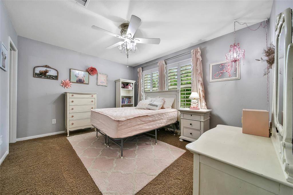 Secondary room #2 with an ensuite bath, plantation shutters, and lighting that is full of character!