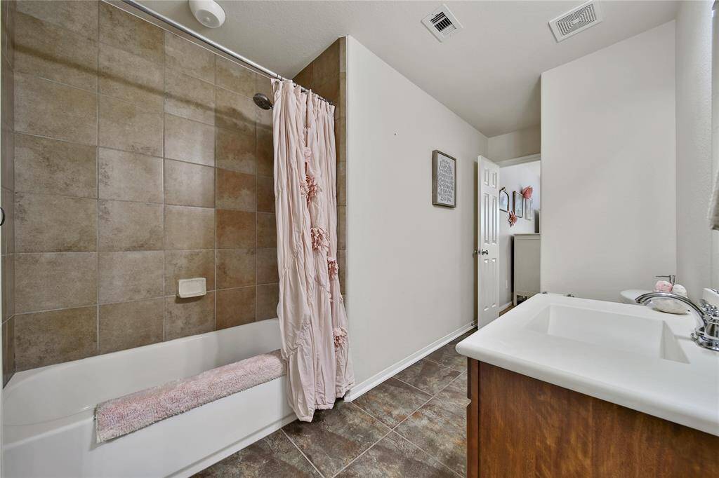 Ensuite bath that opens up to secondary bedroom #2.  Single single with custom storage, and shower/tub combo!