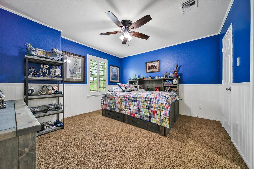 Secondary bedroom #3 with shiplap walls, plantation shutters, ceiling fan for air movement with adjoined jack/jill bathroom.