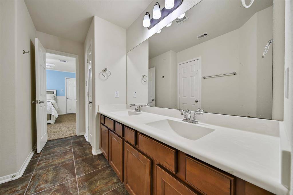 Jack Jill Bathroom with double sinks, plenty of storage and bright lighting serves adjoining bedrooms #3 and #4