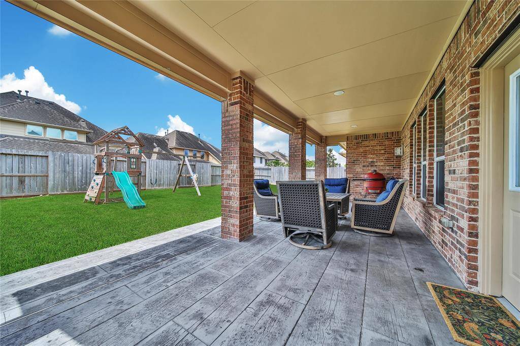 Custom concrete back patio is a feature of this oversized covered patio!