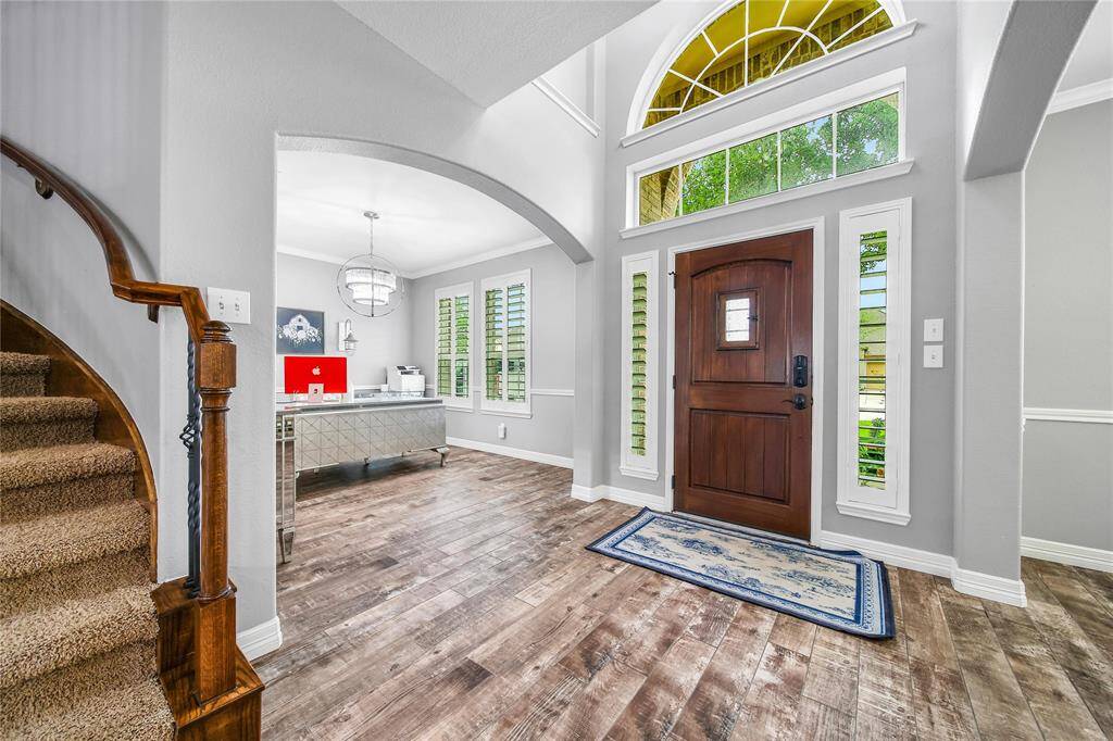 Curved staircase is tucked to the side of the entry creating an openness into the rest of the home.
