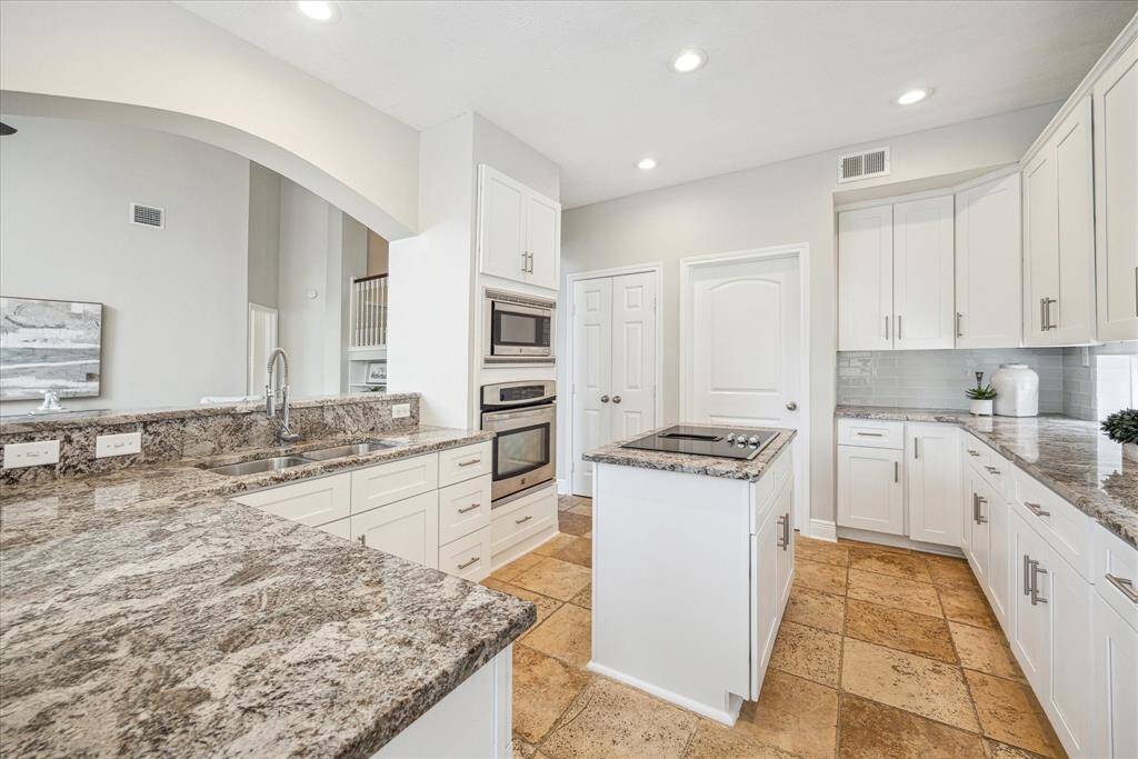 The open-concept design of the kitchen creates a space that is perfect for entertaining family and friends!