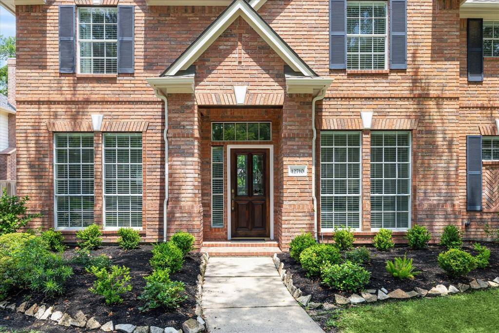 Timeless curb appeal, featuring a beautifully maintained brick exterior.