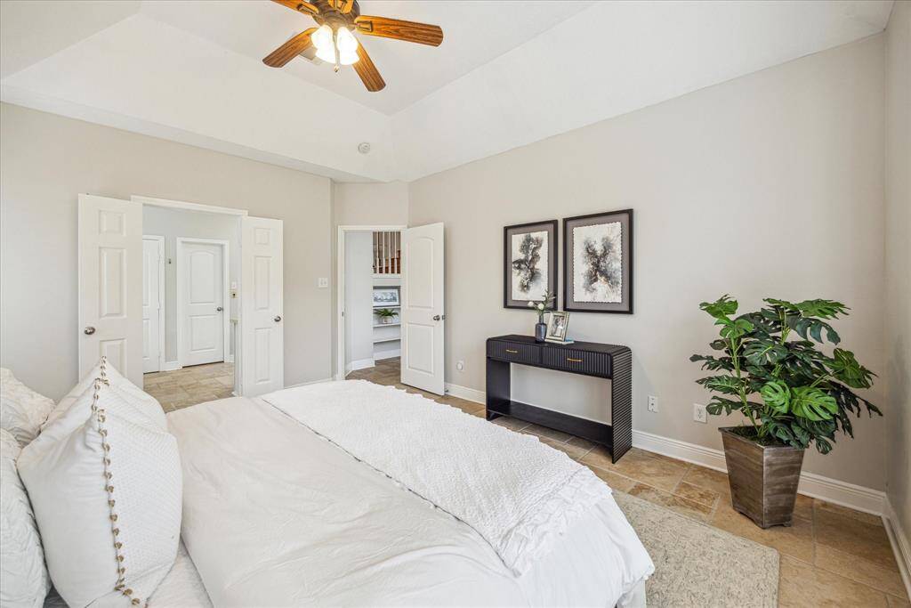 Another view of the primary bedroom leading out to the family room.