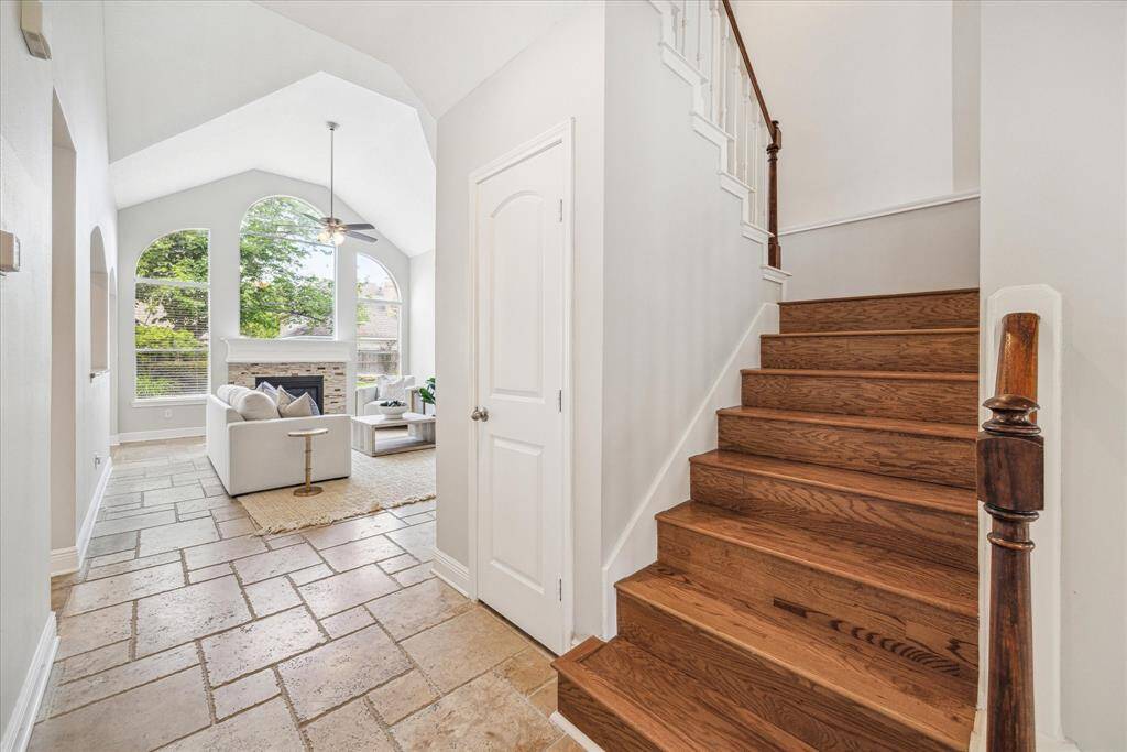 The hardwood staircase leads upstairs to a game room and 3 additional bedrooms.