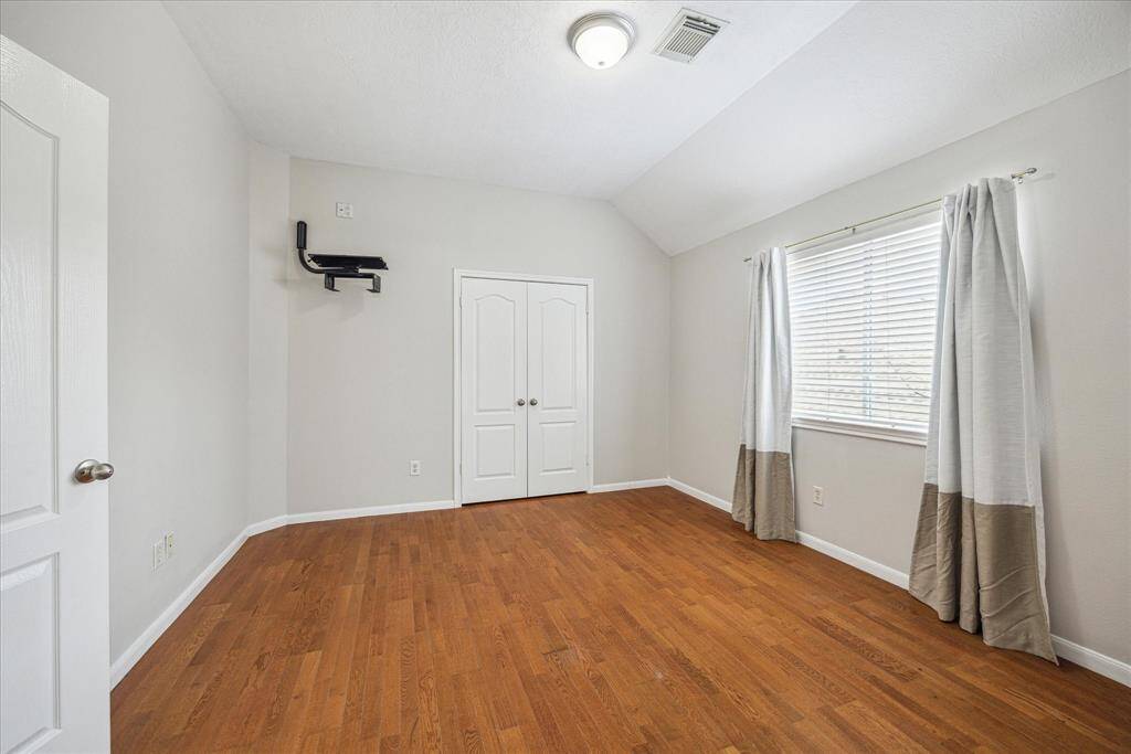 One of three bedrooms upstairs, this spacious room has hardwood flooring, a spacious closet and an ensuite bath.