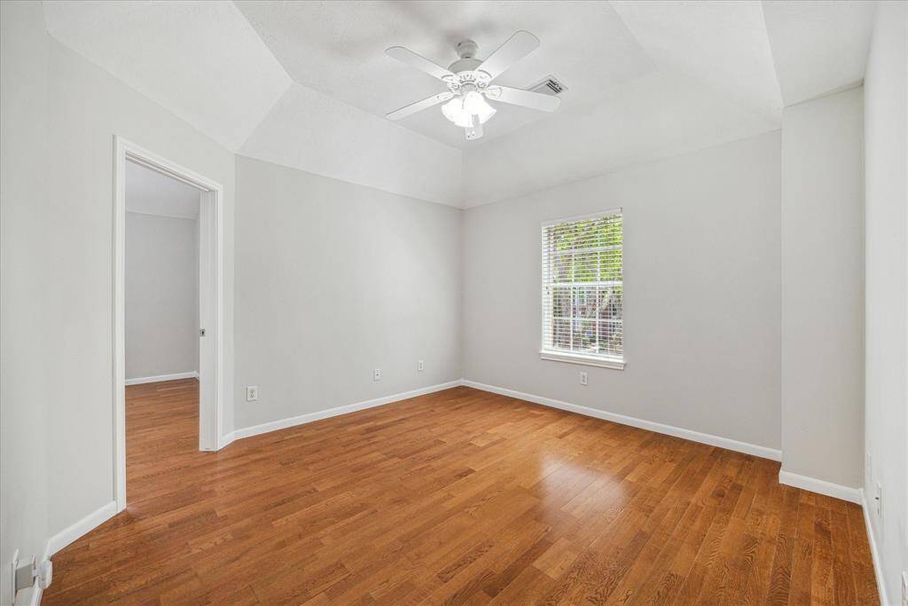 This bedroom has hardwood flooring and shares a Hollywood bath with another bedroom.