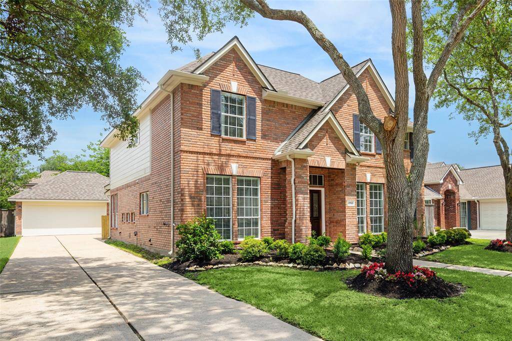 A long drive offers ample off-street parking and leads to an extended 2-car garage with recent epoxy coating.