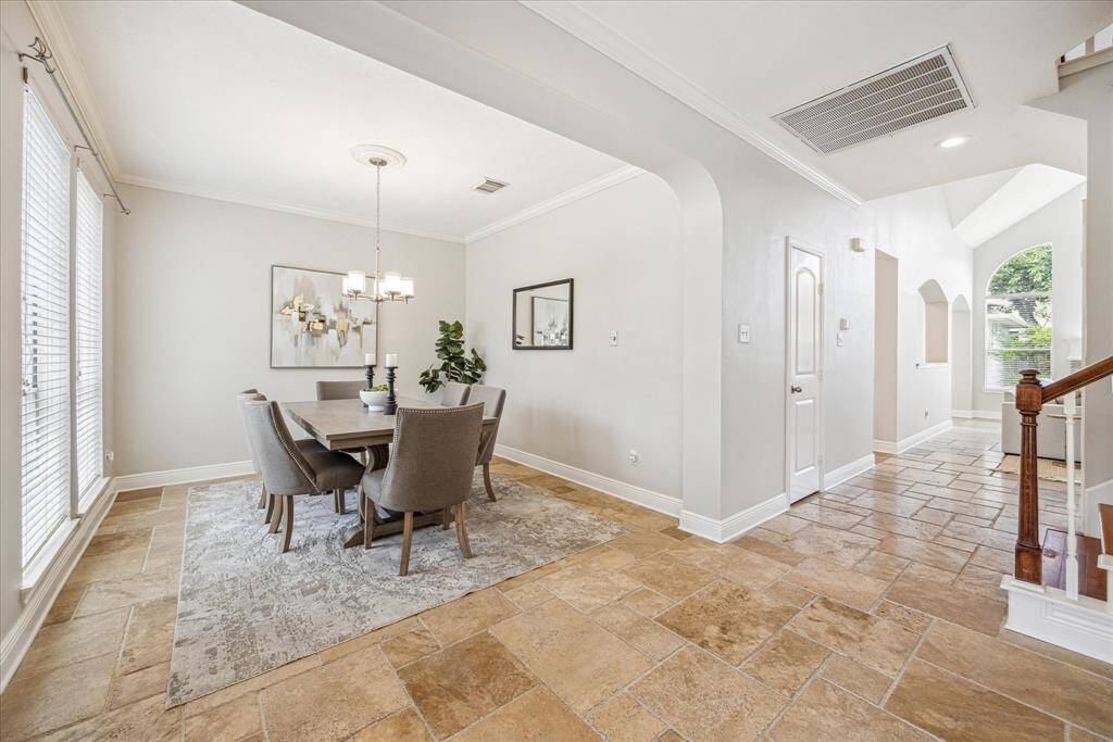 To the left of the foyer is the formal dining room. Large windows offer a view of the front yard and fill the room with natural light.