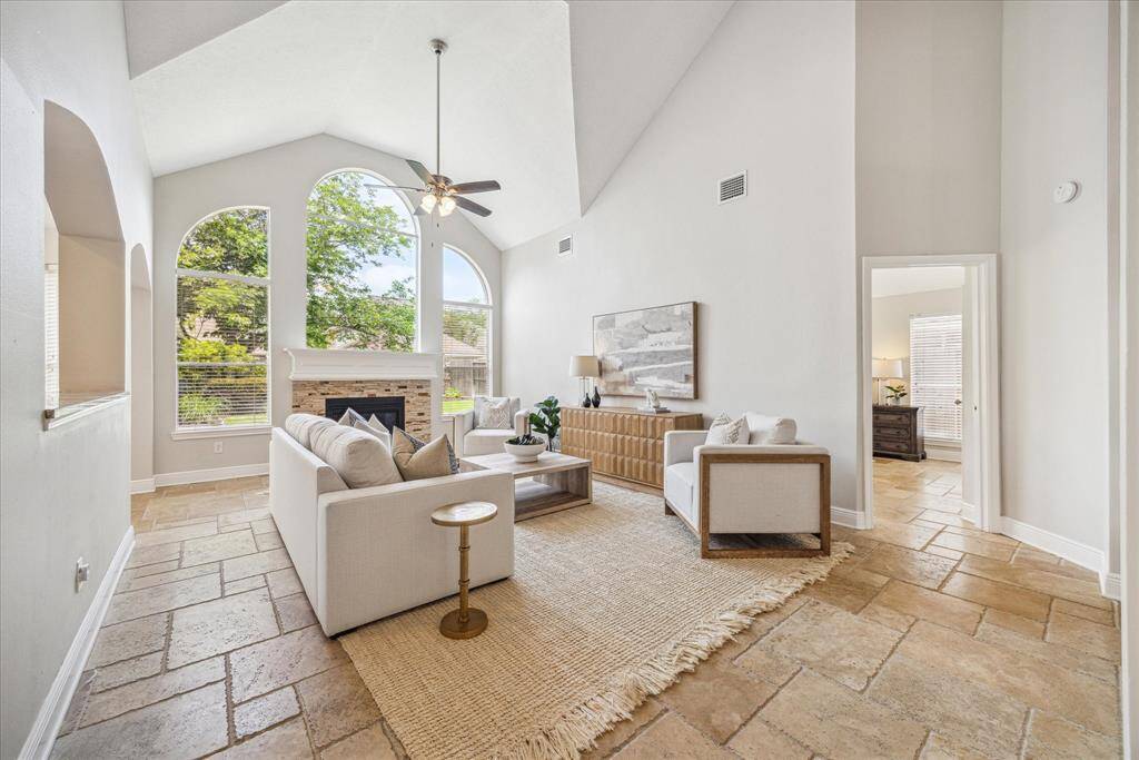 Step into the bright and airy family room, where a stunning wall of windows floods the space with natural light and offers beautiful views of the backyard.
