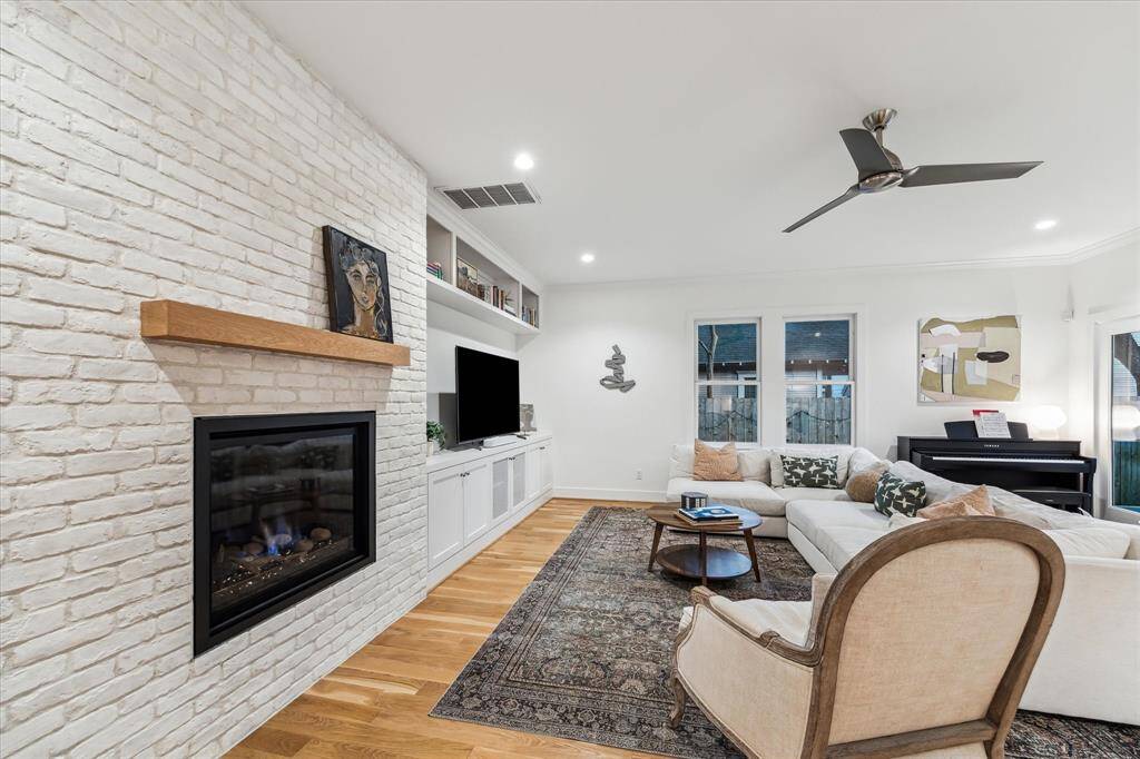 The family room features white oak floors, recessed lighting, a ceiling fan and amazing views of the backyard!