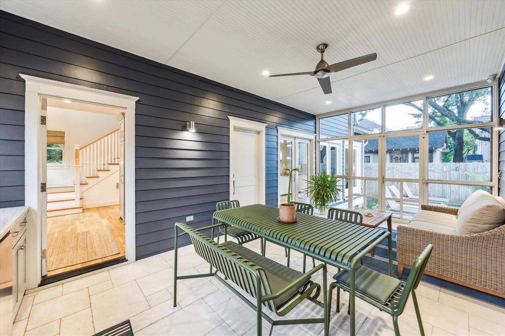 Step outside to the extended screened-in porch with a bar, beverage fridge, and built-in sink—perfect for year-round outdoor enjoyment.