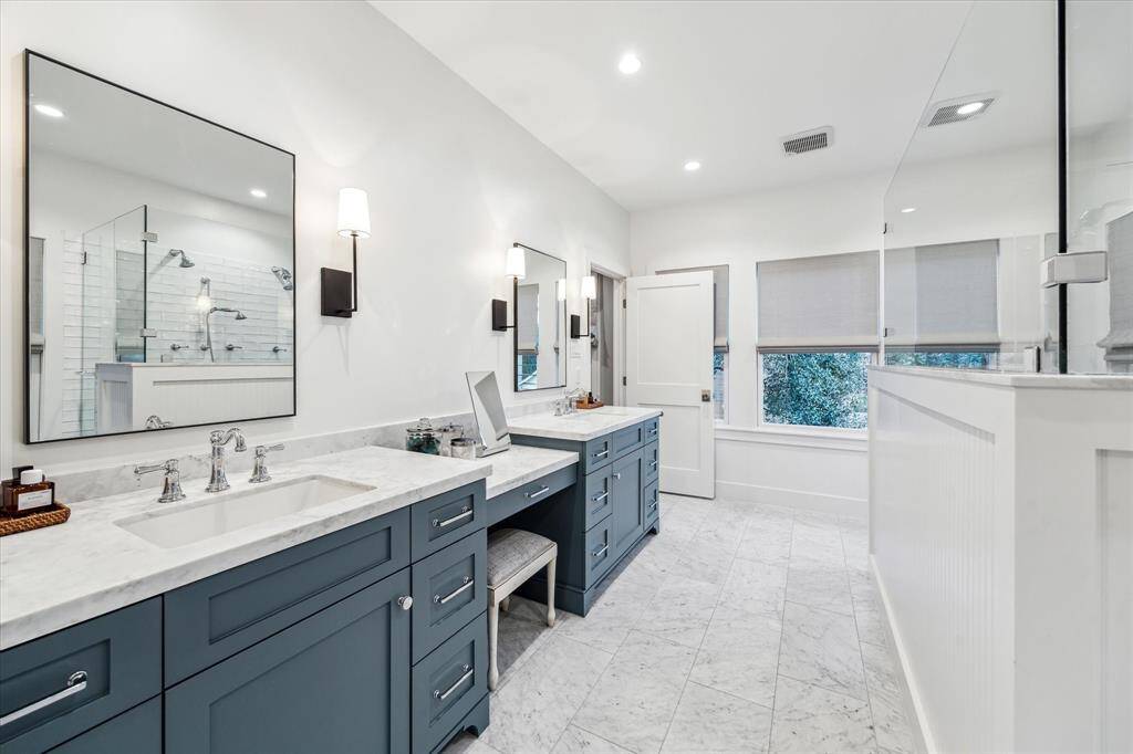 The ensuite bath is a true retreat with marble floors and counters, double vanities and custom shades over the windows. The two west facing windows are tinted with 3M film to reduce heat admission.