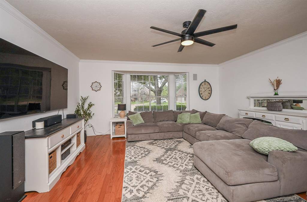 So much room to spread out in this family room with wood flooring