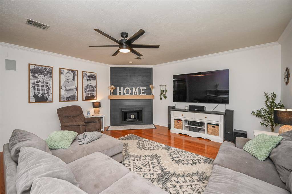 The custom fireplace has a white oak mantle