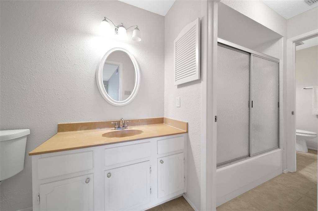 Primary bath side connecting to secondary hall half bath