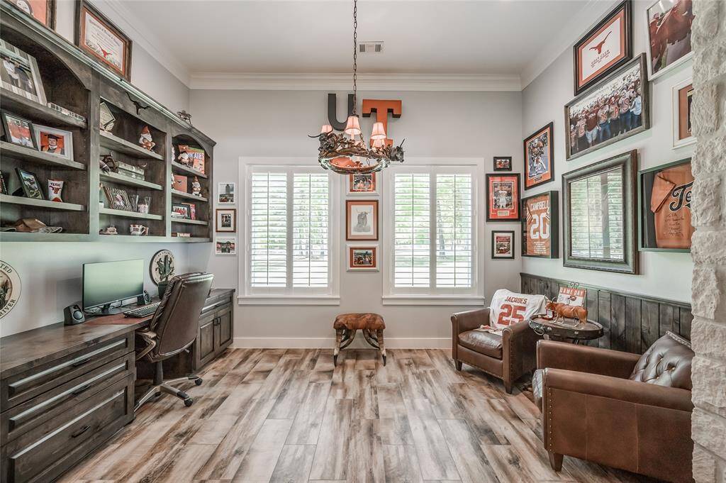 Large study with a custom wall-to-wall desk and built-in shelving.