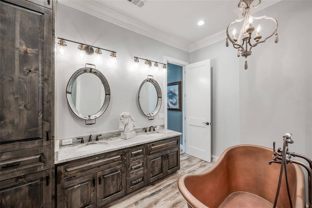 The primary bath has dual sinks and custom cabinetry.