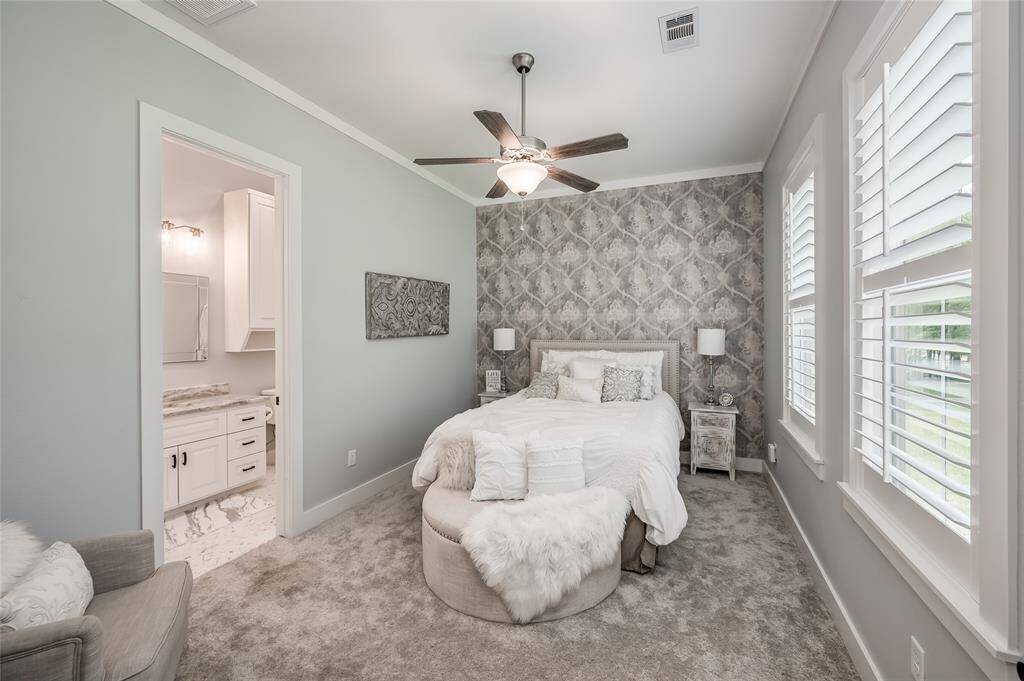 The second bedroom includes an ensuite bathroom with leathered granite countertops and a custom walk-in shower.