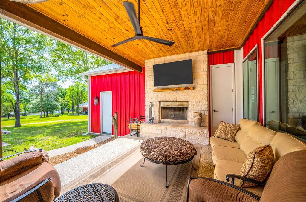 Oversized covered patio off of the main house with a wood-burning stone fireplace.