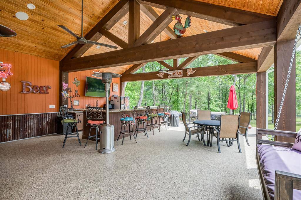 Huge pavilion with wood beams and a outdoor kitchen.
