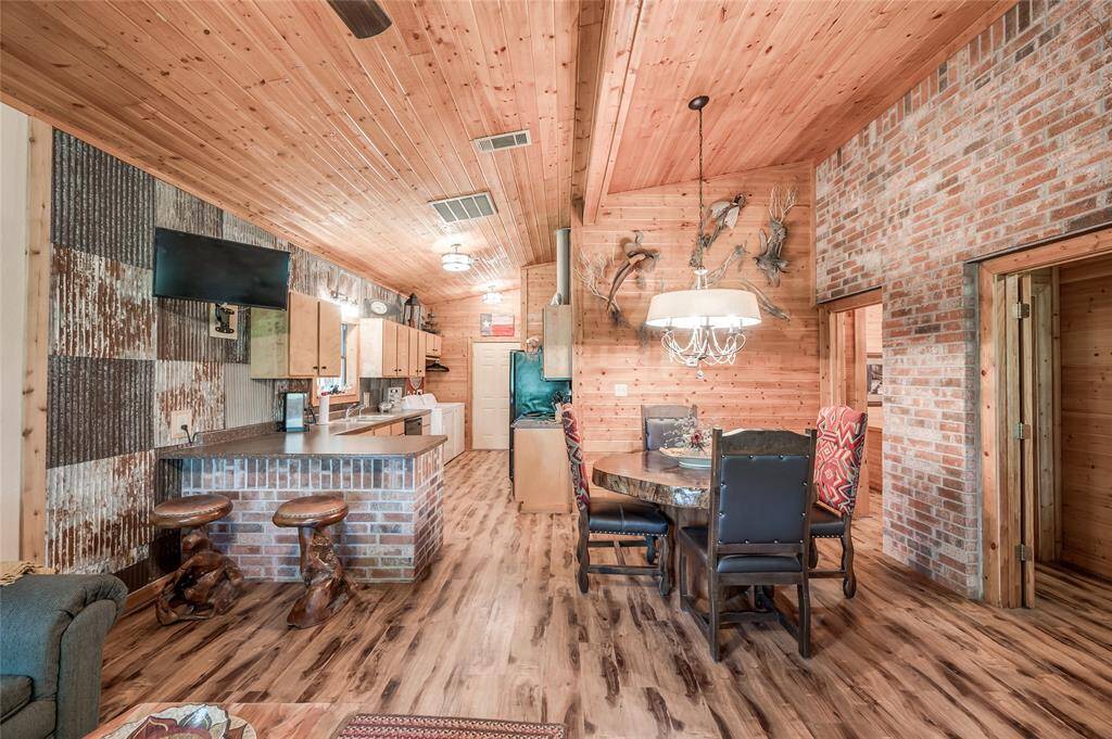 Custom walls in the kitchen with brick accent walls in the breakfast room and living room.