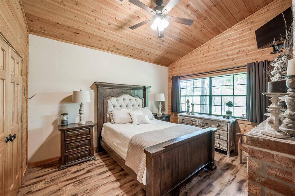 Primary bedroom in the guesthouse with tile flooring and high ceilings.