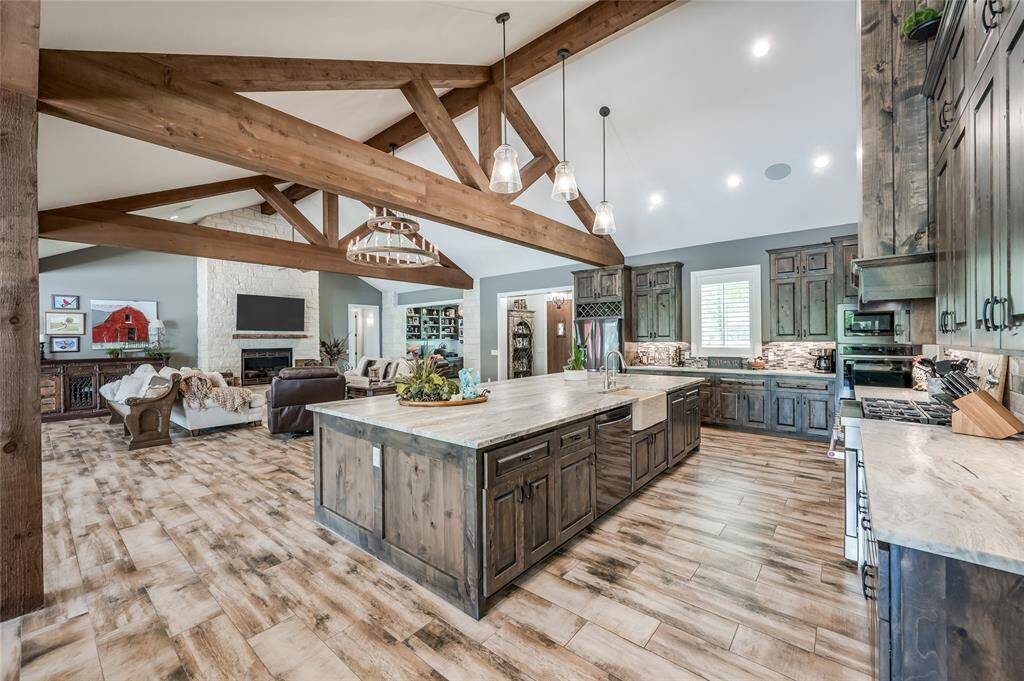 Large wood beams that flank the vaulted ceilings in the main areas of the home.