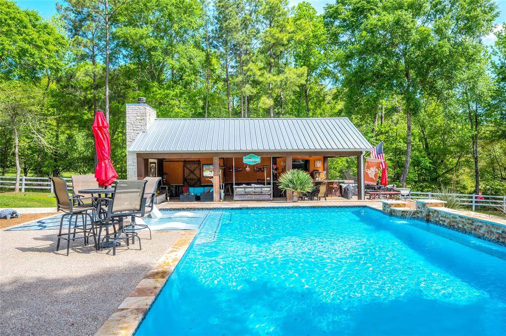 Pavilion features a  huge bar, outdoor kitchen, TV, surround sound, wood-burning fireplace, and half bathroom.