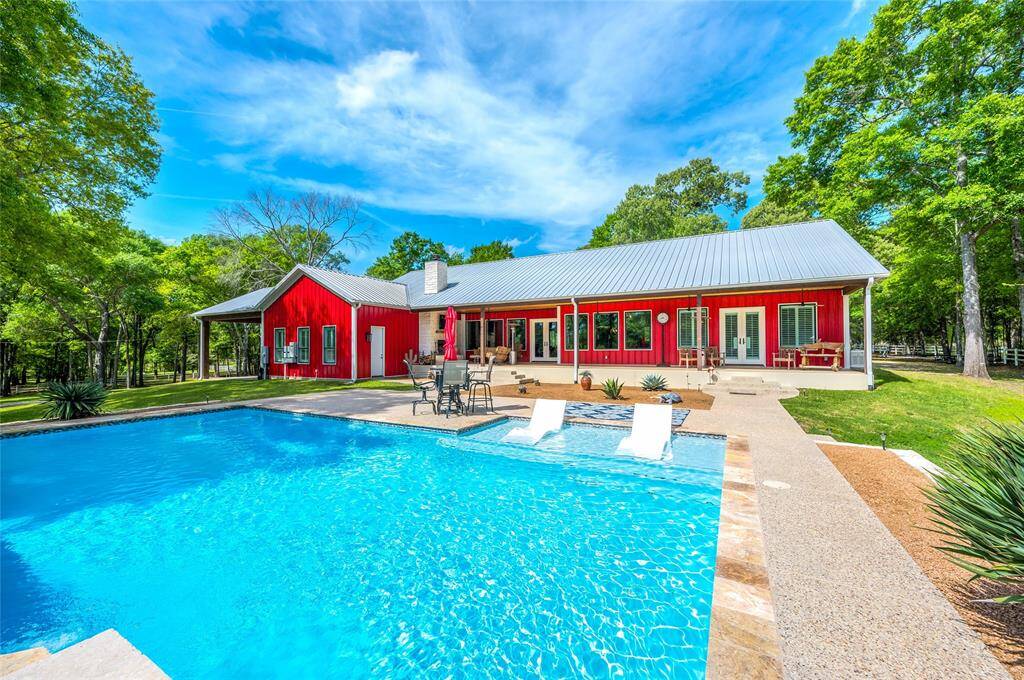 Enjoy basking in the sun in the oversized custom in-ground desert-scape pool.
