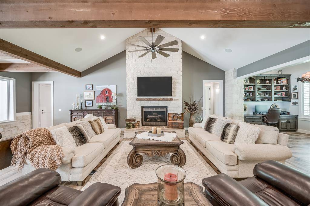 Stunning stone floor-to-ceiling gas log fireplace.