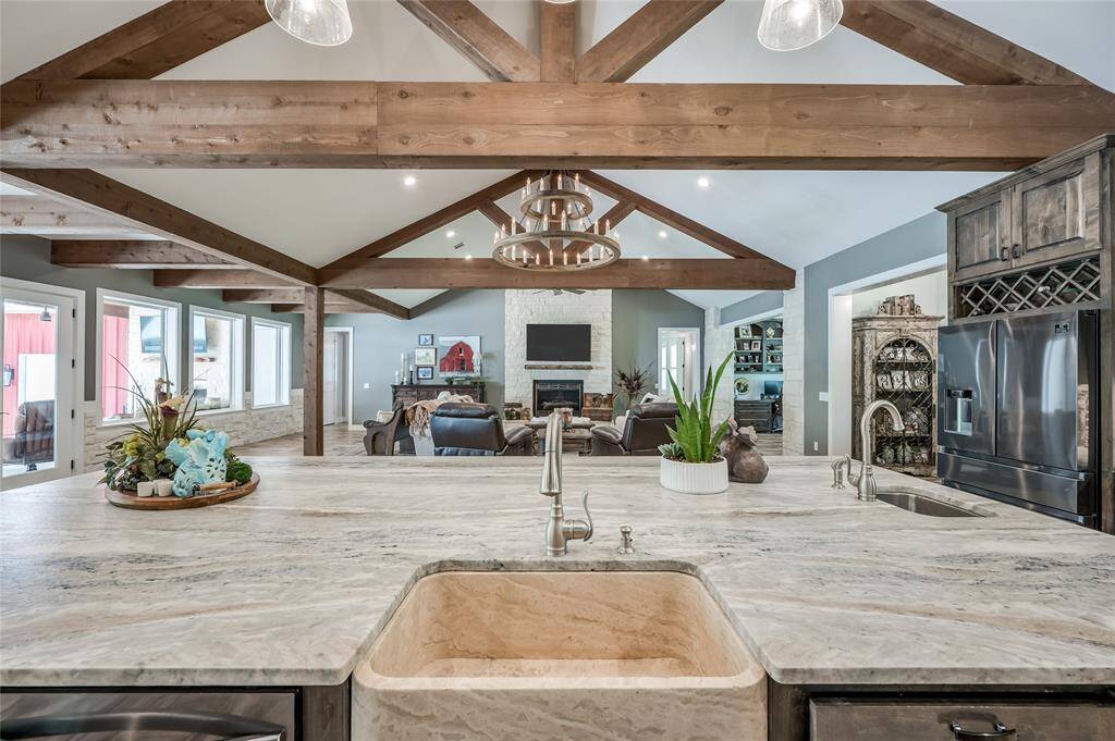 The gourmet kitchen features a custom farmhouse sink with a second countertop sink.