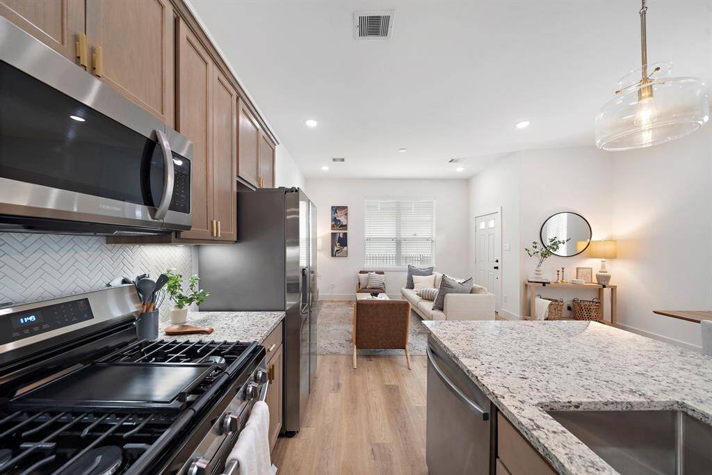 Photos are representative of another completed unit in the same community. Countertops will be white quartz.