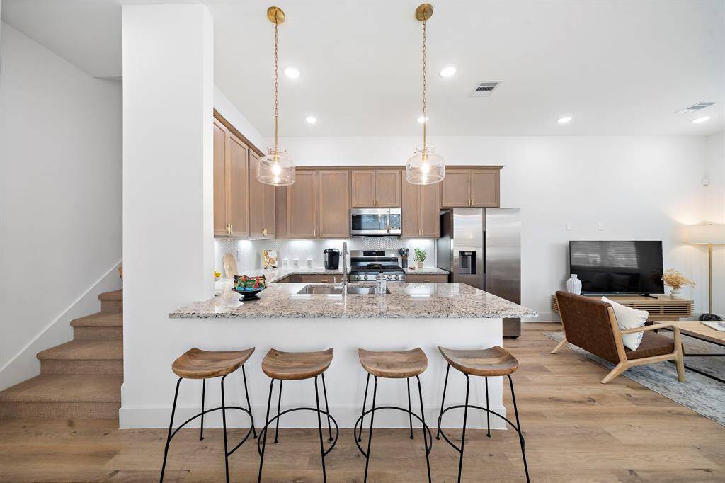 Photos are representative of another completed unit in the same community. Countertops will be white quartz