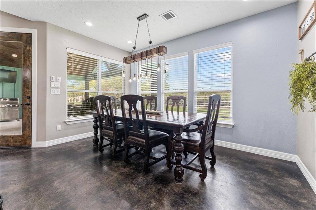 This dining room is off the kitchen. It allows for large gatherings to dine together or simply enjoy your breakfast as you enjoy looking on to private tree farm. These views are your oasis.