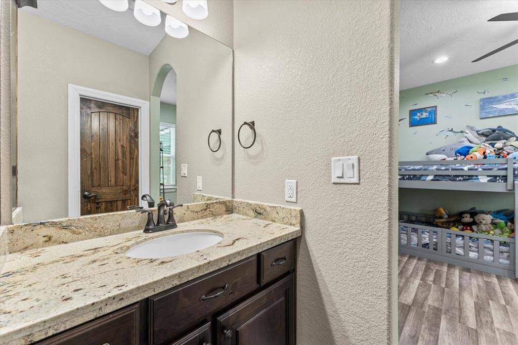 The secondary bedrooms are connected by a convenient Jack and Jill bathroom, each featuring its own private vanity area, generous closet space, and ample storage. A shared tub/shower combo completes the thoughtfully designed layout.