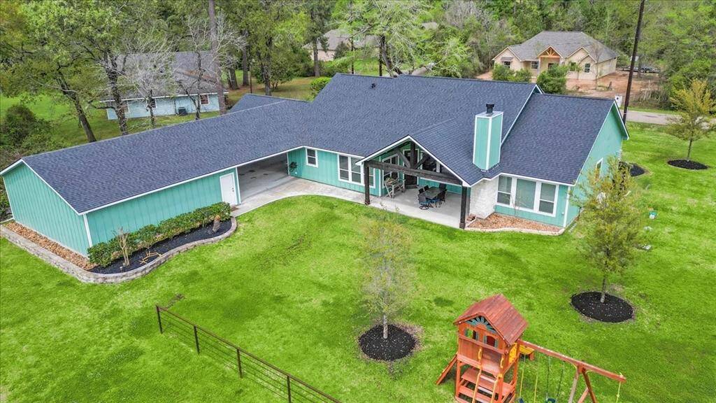 This spacious home features a large, covered patio, with gabled ceilings and outdoor fireplace. It sits on a well-manicured half-acre+ lot with mature trees.