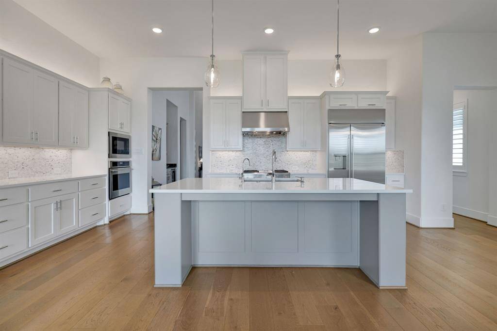 The kitchen features under cabinet lighting and an abundance of storage.