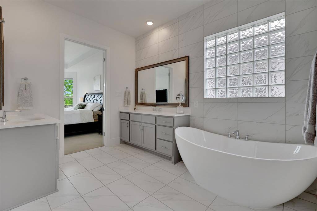 The stunning en-suite primary bath features a soaking tub and double vanities.