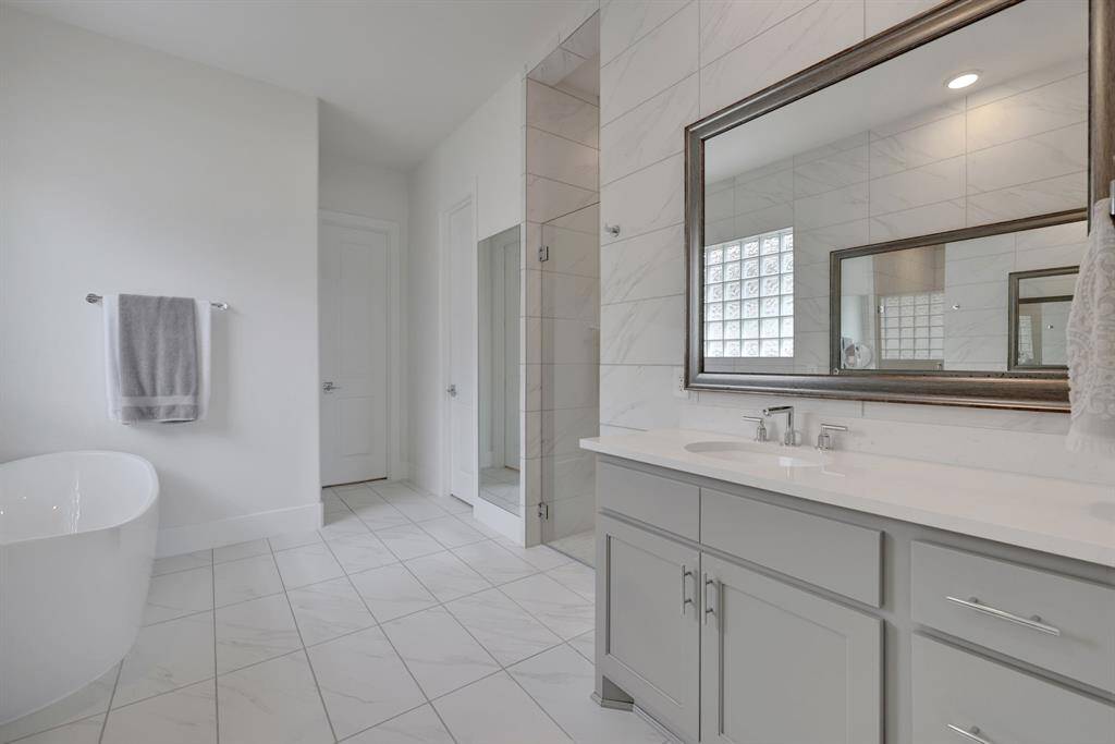 The primary bath has a walk-in shower and separate tub.