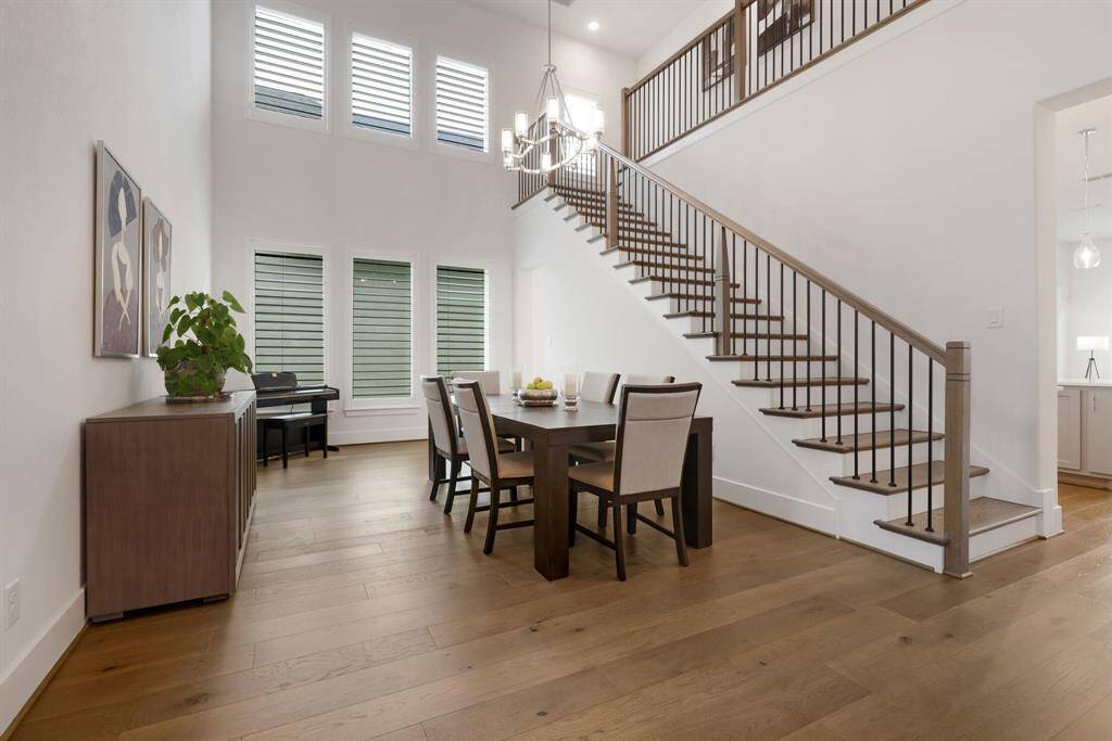 The custom wood staircase features stunning wrought iron details.